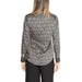 Long-sleeved black and white patterned blouse with curved hemline and lapel collar