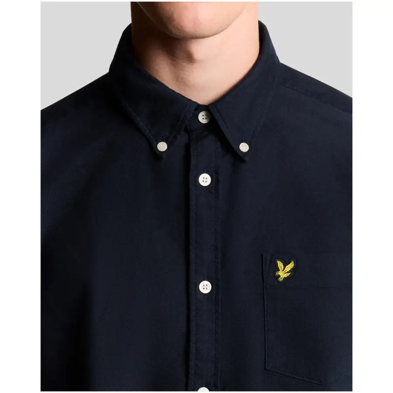 Navy blue lyle & scott long sleeve cotton shirt with white buttons and yellow embroidered bird logo on chest pocket
