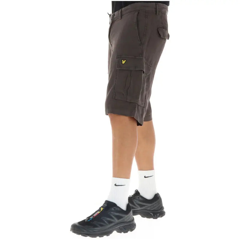 Cargo shorts with multiple pockets and a camouflage pattern in olive green, black, brown, and tan.