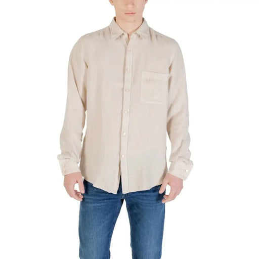 Man wearing a beige button-down shirt for men, stylish and casual wear
