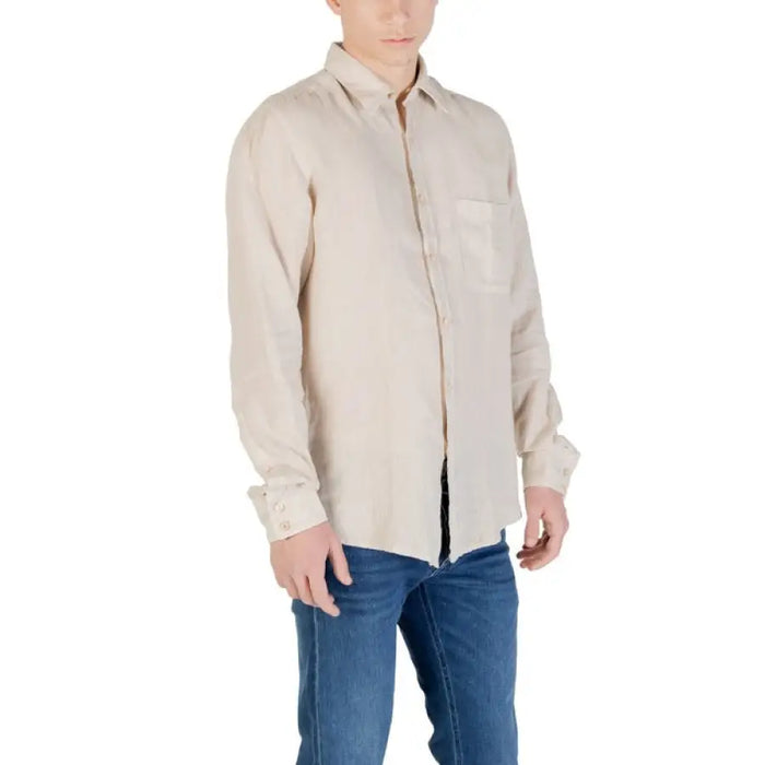 Man in a beige long-sleeved button down shirt and blue jeans for men footwear