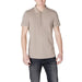 Man wearing beige polo shirt and dark jeans, showcasing Armani Exchange Men’s Blue Cotton Polo Shirt