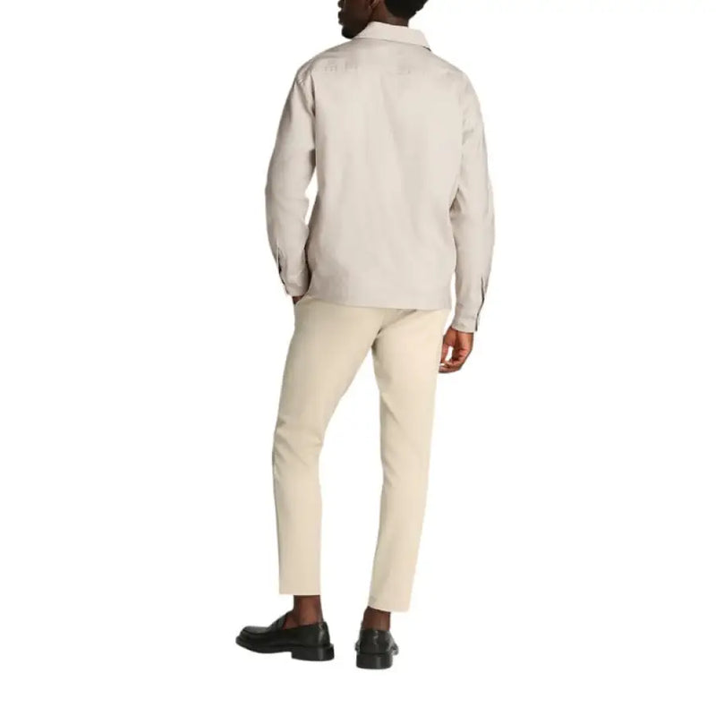 Man wearing a beige shirt jacket, ideal for stylish mens outdoor wear