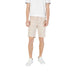Man wearing beige shorts and white sneakers from Mens Casual Shorts T Shirt And Sneaker Collection
