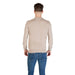 Man wearing beige long-sleeved sweater and blue jeans for the product listing