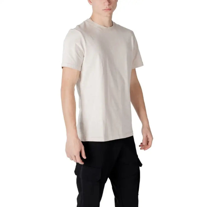 Man wearing beige t-shirt and black pants showcasing Antony Morato Men’s White Round Neck Cotton T-Shirt