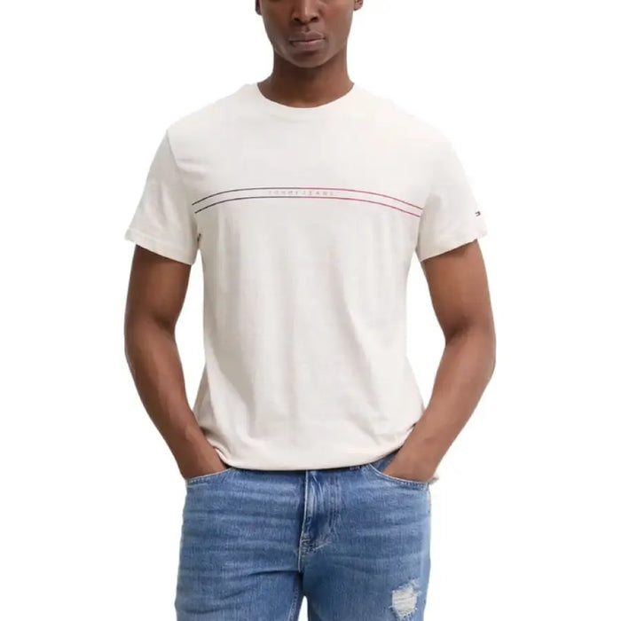 Man wearing a beige t-shirt and blue jeans displayed in Tommy Hilfiger Navy Blue T-Shirt product image