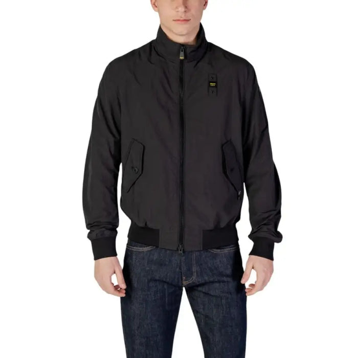 Man in a black bomber jacket paired with jeans for stylish casual wear