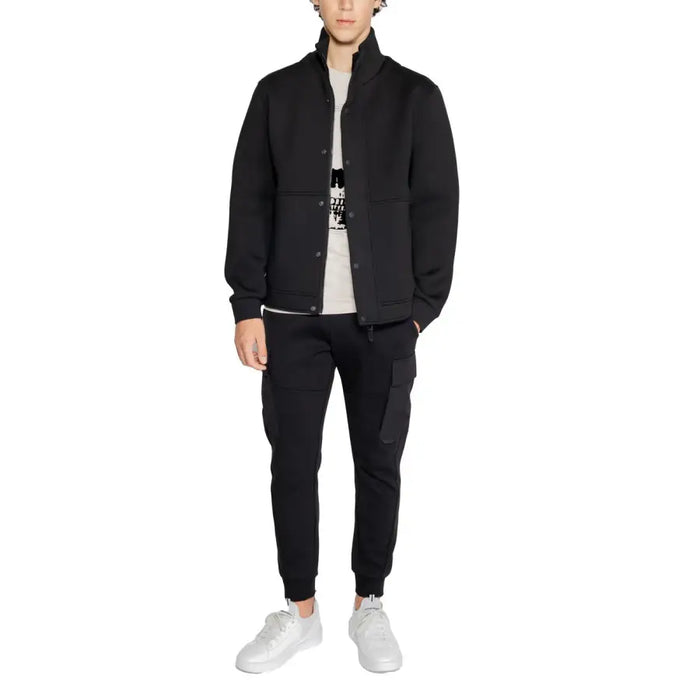 Man wearing a black jacket and pants ensemble for the Black Button Up Jacket And Pants product display