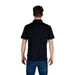Man wearing Armani Exchange black polo shirt and blue jeans in stylish casual look