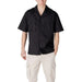 Man wearing Antony Morato Black V Neck Button Shirt with beige cargo pants