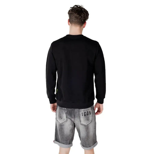 Man wearing Black Sweatshirt with Icon Lettering and gray denim shorts