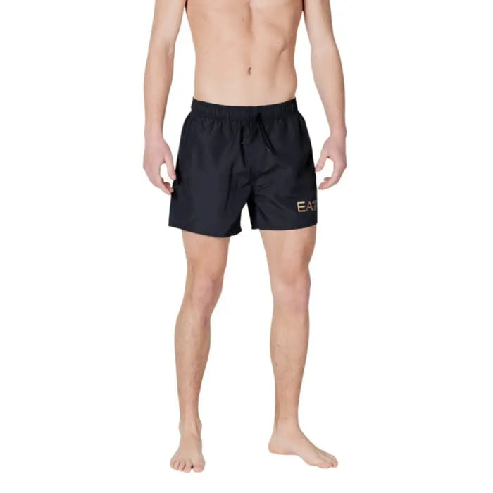 Man in black swim trunks from Ea7 Men’s Black Swimwear for Spring and Summer