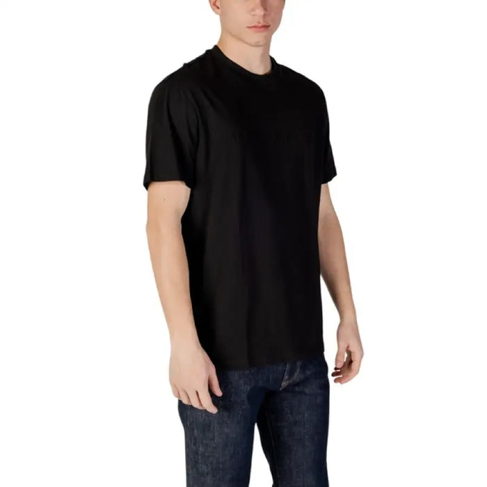 Man in black t-shirt and jeans showcasing Armani Exchange Men Black Cotton T-Shirt