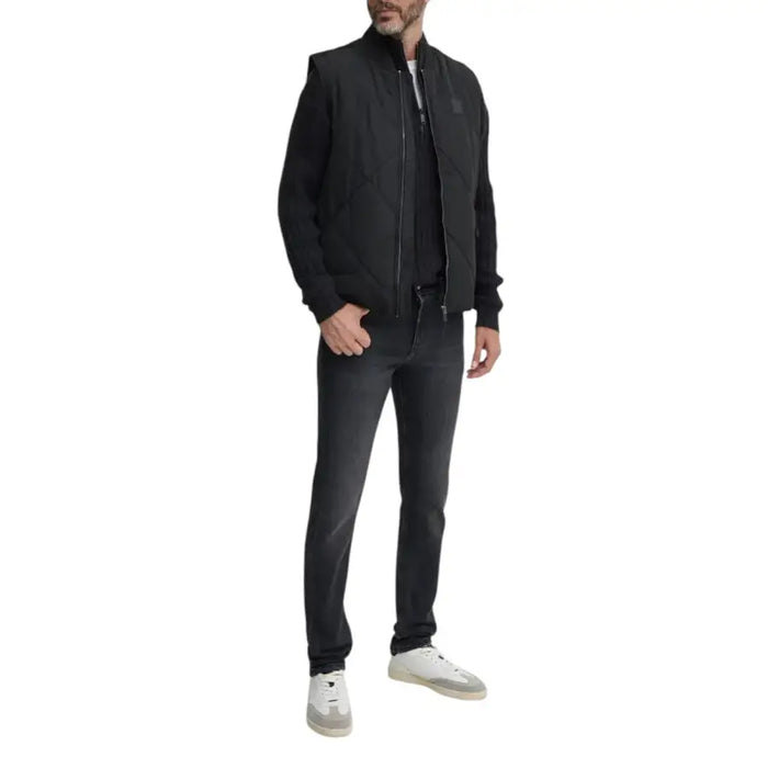 Man wearing black vest and jeans modeling the Black Ribbed Knit Sweater for Men