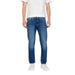 Man wearing blue denim jeans and a white t-shirt showcasing Blue Denim Jeans and White Sneakers