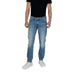 Man modeling Guess Men Blue Jeans from the Spring Summer Collection with white sneakers