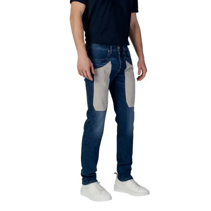 Man in Jeckerson Blue Jeans with gray patches, perfect for Spring Summer style
