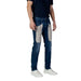 Man in Jeckerson Blue Jeans with gray patches, perfect for Spring Summer style
