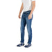Man wearing blue denim jeans and sneakers showcasing the Men’s Blue Denim Jeans product