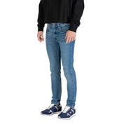 Man wearing light blue denim jeans and sneakers standing confidently