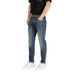 Man dressed in Blue Jeans and White Sneakers, showcasing men’s casual fashion