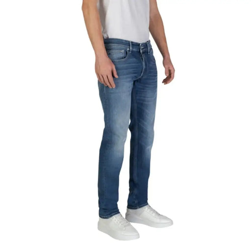 Man in Replay Men Blue Trousers with Worn Out Effect showcasing stylish denim