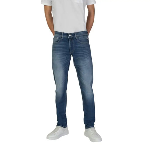 Man in blue jeans and white sneakers showcasing Replay Men Blue Trousers with worn effect