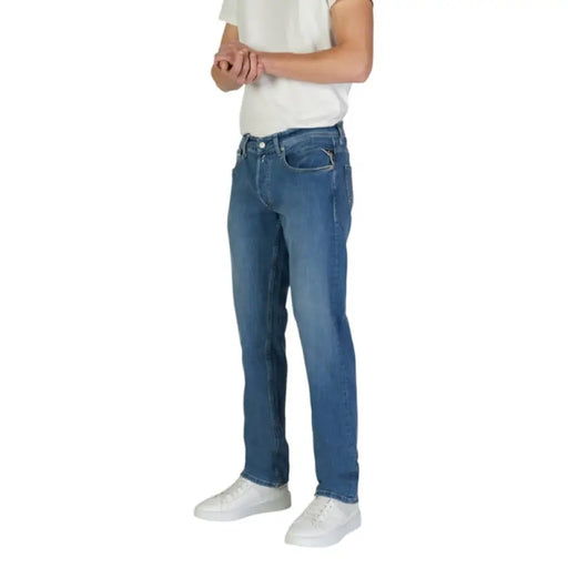 Man in blue jeans and white sneakers showcasing Replay Men’s Blue Jeans with Zip Closure