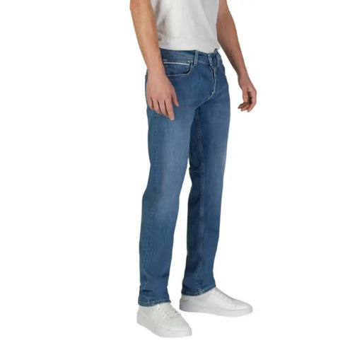 Man wearing Replay Men’s Blue Jeans with Zip and Button Closure in casual setting