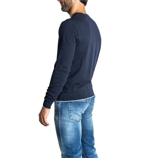 Man wearing a blue long-sleeved shirt and jeans from Blue Shirt and Jeans with Navy Blue V Neck Sweater product