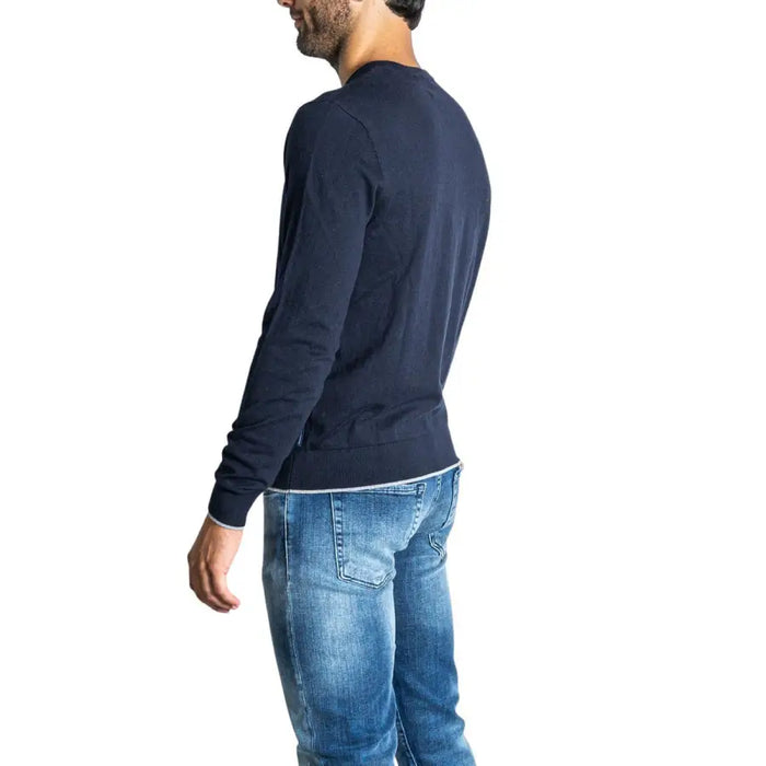 Man wearing a blue long-sleeved shirt and jeans from Blue Shirt and Jeans with Navy Blue V Neck Sweater product