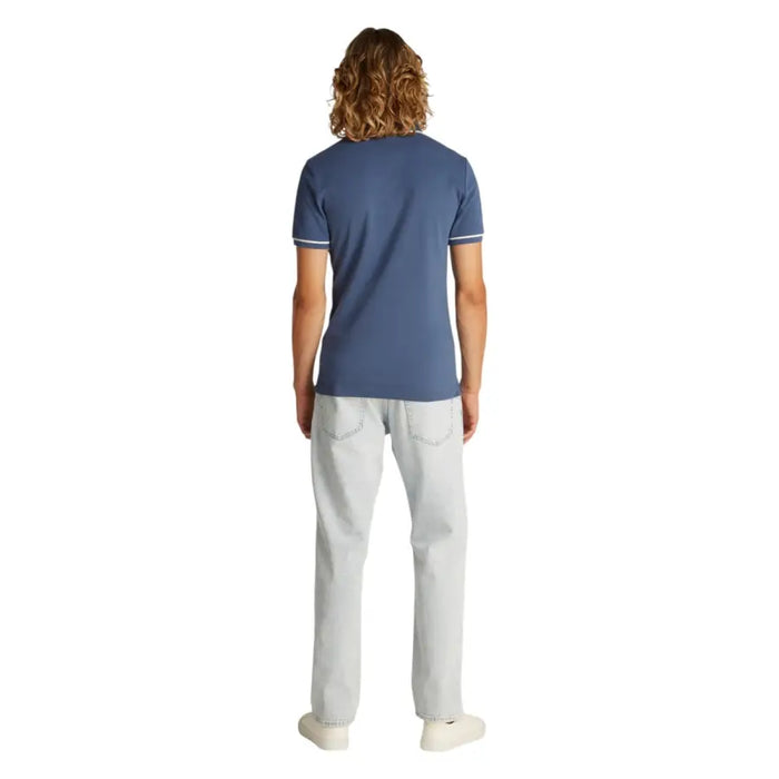 Man wearing Blue Polo Shirt with White Trim and Lightwash Jeans for Men