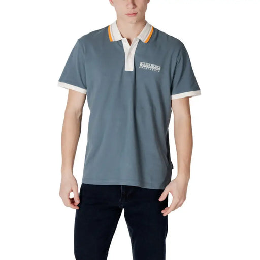 Man wearing a blue polo shirt from the Napapijri Men Green Cotton Polo Shirt collection