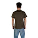 Man in brown t-shirt and blue jeans wearing Tommy Hilfiger Men’s Green Cotton T Shirt