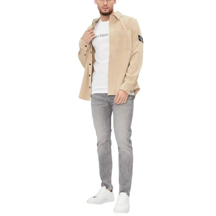 Man in casual attire wearing Calvin Klein white crew neck T-shirt for men