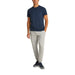 Man wearing navy T shirt and gray pants in casual attire