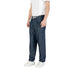 Man wearing casual blue denim drawstring pants and white shoes