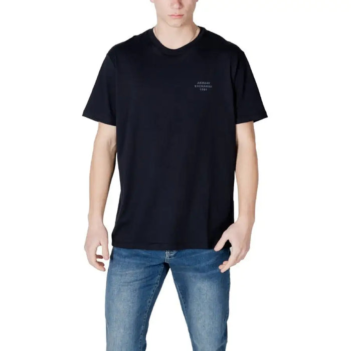 Man in a dark blue t-shirt and jeans showcasing Armani Exchange Men White Cotton T-Shirt