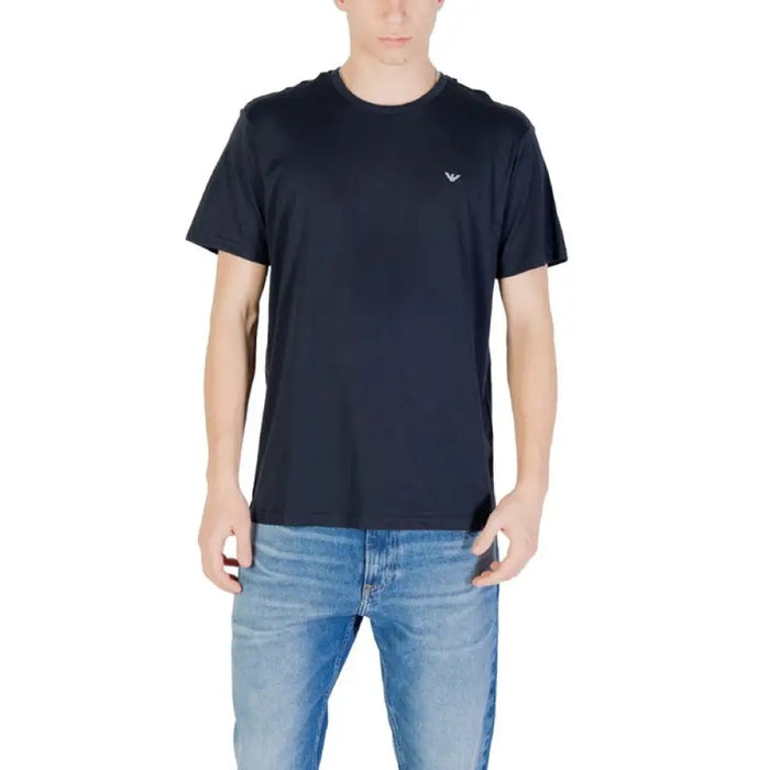 Man wearing a dark blue crew neck T-shirt and blue jeans showcasing the product outfit