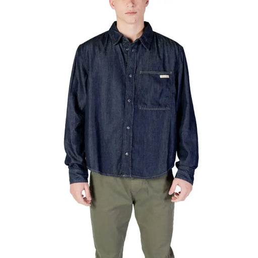 Man in dark blue denim shirt and olive green pants for Calvin Klein Men’s Blue Shirt