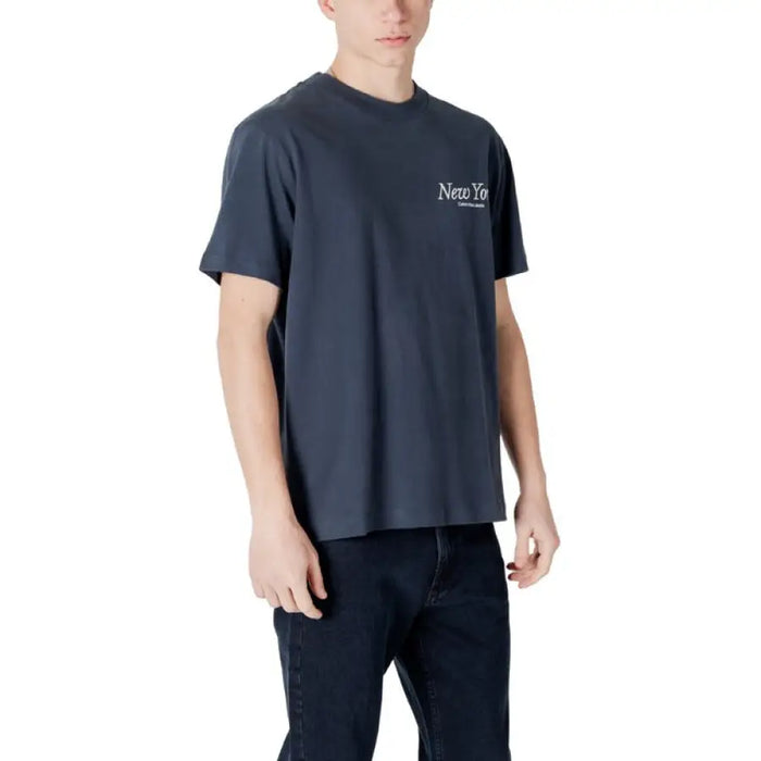Man wearing dark blue T-shirt and jeans showcasing Mens Blue and Gray T-Shirts and Dark Jeans