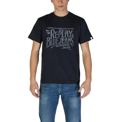 Man wearing navy blue graphic T-shirt and blue jeans for Men product display