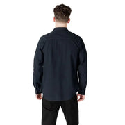 Man wearing a dark button-down shirt, suitable for formal and casual occasions