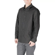 Man wearing a dark wrinkled long sleeved button down shirt