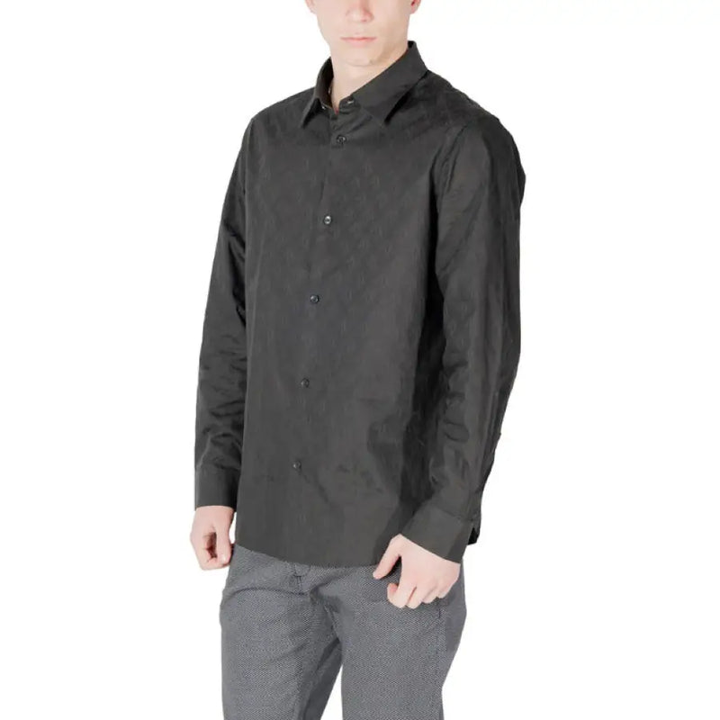 Man wearing a dark wrinkled long sleeved button down shirt