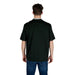Man in dark green short-sleeved shirt and blue jeans showcasing Armani Exchange T Shirt