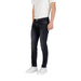 Man wearing dark wash slim fit jeans demonstrating a stylish casual look