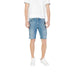 Man modeling Men’s Denim Shorts and White Sneakers in a casual outdoor setting