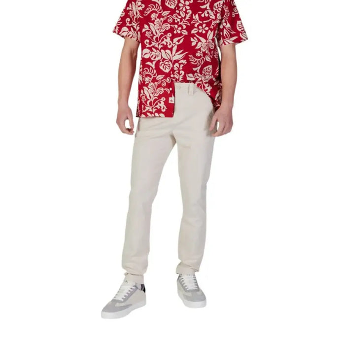 Man wearing floral shirt and chinos with Tommy Hilfiger Men’s Blue Jeans Trousers